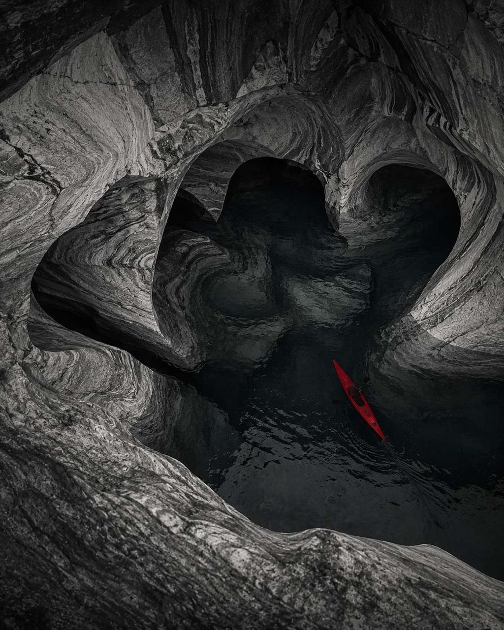 Eroded stone chambers with a thin red fissure at the centre.