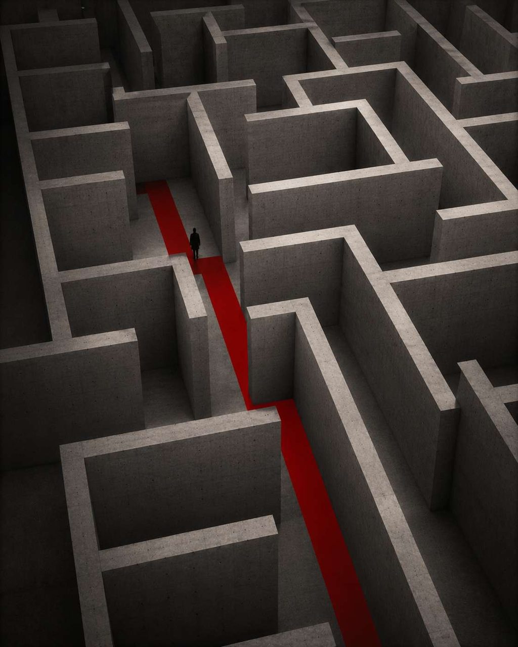 An aerial view of a vast concrete labyrinth with a single red path traced through it.